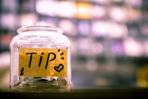 a jar sitting on a counter with the word "tips" written on it
